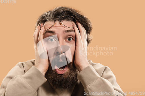 Image of Half-length portrait of Caucasian man isolated over light yellow background.