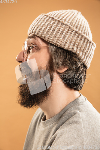 Image of Portrait of Caucasian man in glasses and hat isolated on light background.