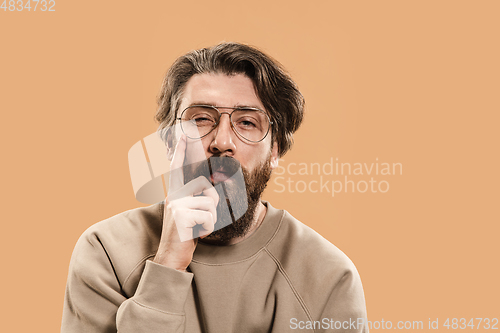 Image of Half-length portrait of Caucasian man isolated over light yellow background.