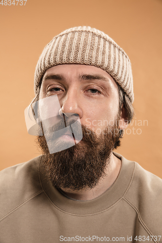 Image of Half-length portrait of Caucasian man isolated over light yellow background.