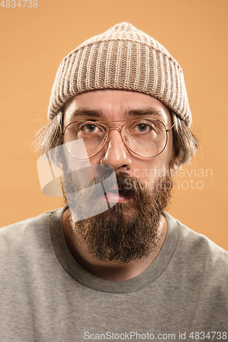 Image of Portrait of Caucasian man in glasses and hat isolated on light background.