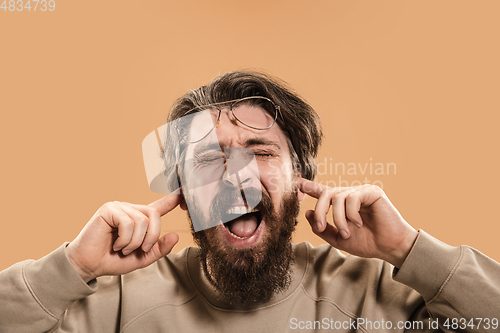 Image of Half-length portrait of Caucasian man isolated over light yellow background.