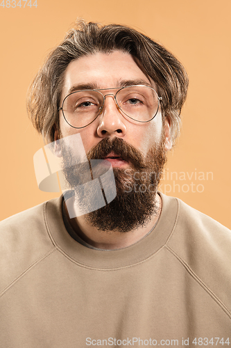 Image of Half-length portrait of Caucasian man isolated over light yellow background.