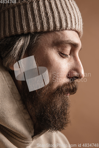 Image of Close-up Caucasian mustached and bearded man in hat isolated on light background