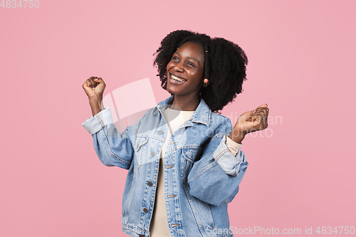 Image of African-american woman portrait isolated on pink studio background with copyspace
