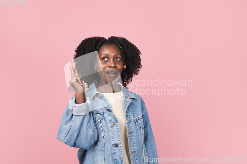 Image of African-american woman portrait isolated on pink studio background with copyspace