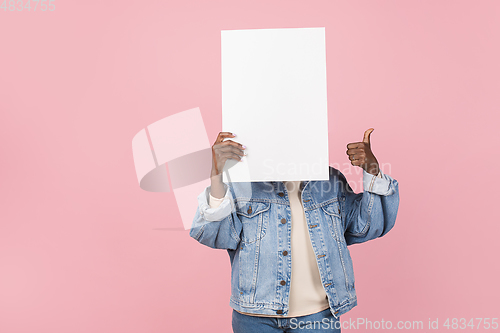 Image of African-american woman portrait isolated on pink studio background with copyspace