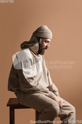 Image of Half-length portrait of Caucasian man isolated over light yellow background.