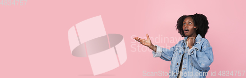 Image of African-american woman portrait isolated on pink studio background with copyspace