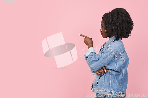 Image of African-american woman portrait isolated on pink studio background with copyspace