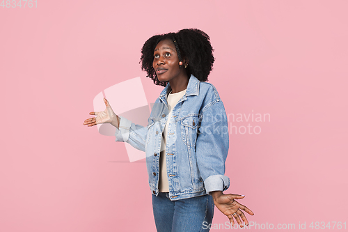 Image of African-american woman portrait isolated on pink studio background with copyspace