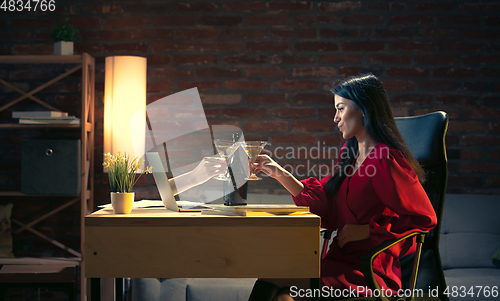 Image of Young Caucasian woman talking with friend online through laptop.