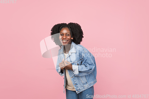 Image of African-american woman portrait isolated on pink studio background with copyspace