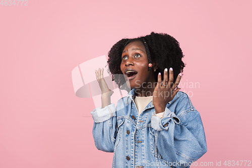 Image of African-american woman portrait isolated on pink studio background with copyspace
