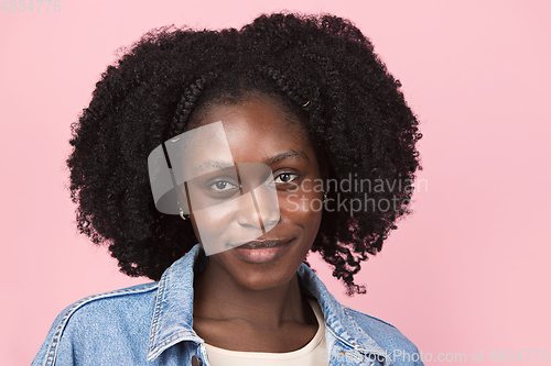 Image of African-american woman portrait isolated on pink studio background with copyspace