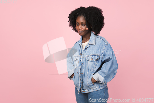 Image of African-american woman portrait isolated on pink studio background with copyspace