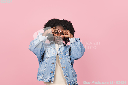 Image of African-american woman portrait isolated on pink studio background with copyspace