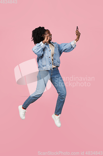 Image of African-american woman portrait isolated on pink studio background with copyspace