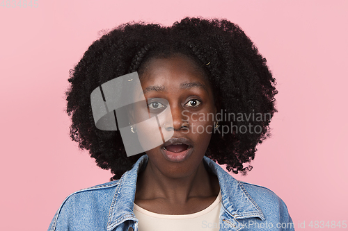 Image of African-american woman portrait isolated on pink studio background with copyspace