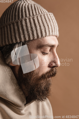 Image of Close-up Caucasian mustached and bearded man in hat isolated on light background