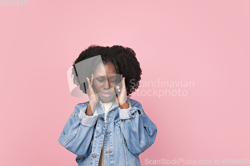 Image of African-american woman portrait isolated on pink studio background with copyspace