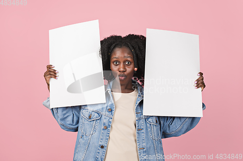 Image of African-american woman portrait isolated on pink studio background with copyspace