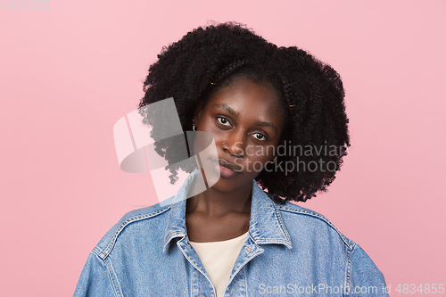 Image of African-american woman portrait isolated on pink studio background with copyspace