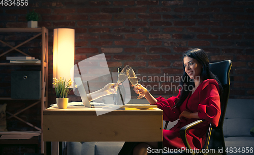 Image of Young Caucasian woman talking with friend online through laptop.