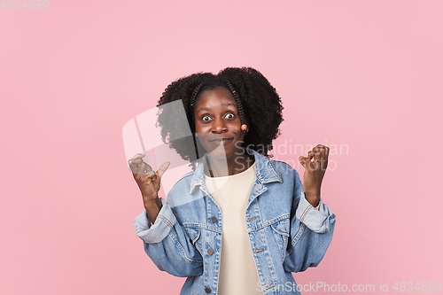 Image of African-american woman portrait isolated on pink studio background with copyspace