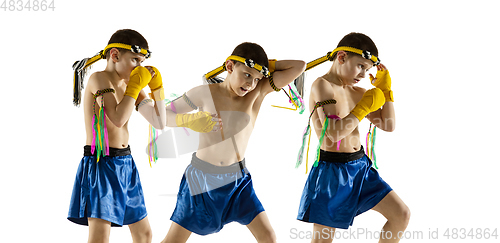 Image of Little boy exercising thai boxing on white background. Fighter practicing, training in martial arts in action, motion. Evolution of movement, catching moment.