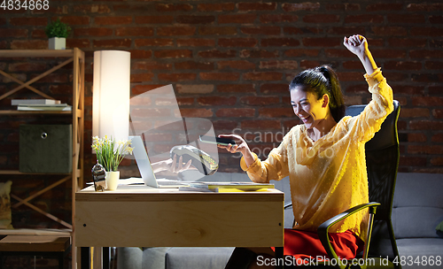 Image of Young Caucasian woman using online banking through laptop.