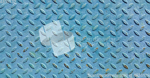 Image of Old metal diamond plate covered with blue paint