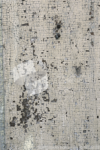 Image of cracked old paint layer on wood