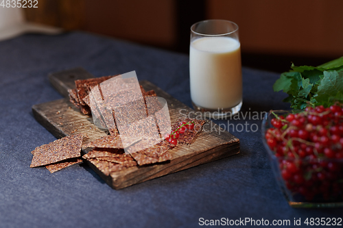 Image of Vegan flaxseed bread with berries next to the glass with coconut