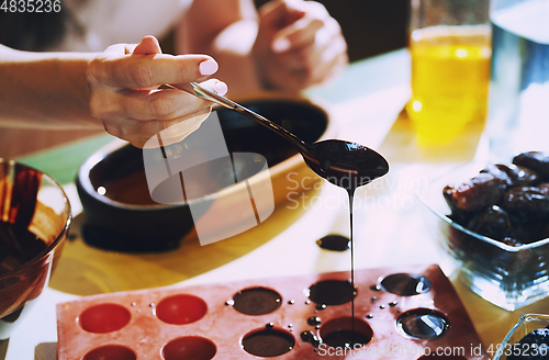 Image of Staying at home woman preparing handmade vegetarian chocolate tr