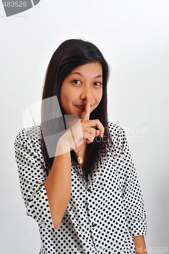 Image of young asian with finger on her lips