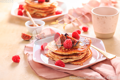 Image of Sweet curd cheese pancakes with fresh raspberry, figs and maple sirup