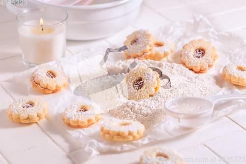 Image of Homemade Christmas cookies with baking ingredients in white