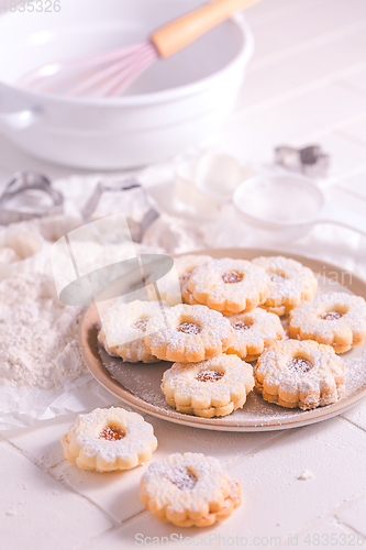 Image of Homemade Christmas cookies with baking ingredients in white