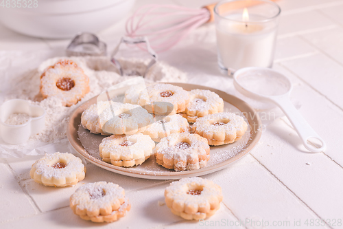 Image of Homemade Christmas cookies with baking ingredients in white