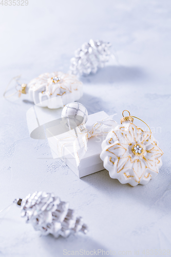 Image of Christmas ornaments and small present in white