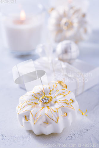 Image of Christmas ornaments and small present in white