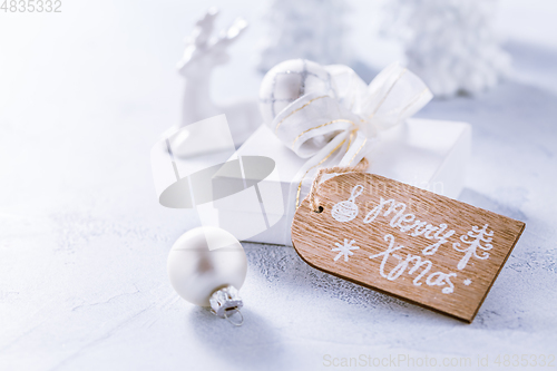 Image of Christmas ornaments and small present in white