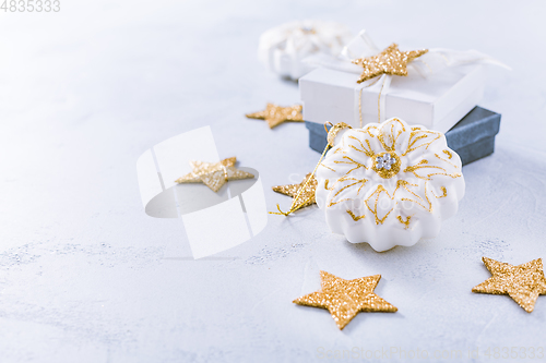 Image of Christmas ornaments and small present in white