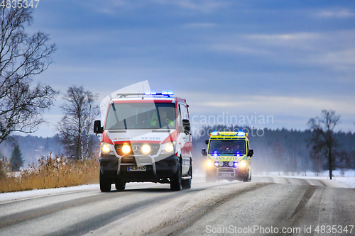 Image of Two Ambulances on Call on Winter Road