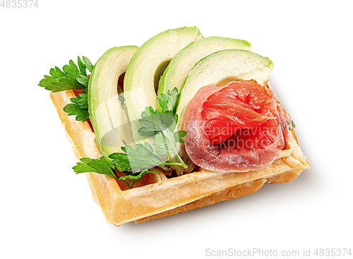Image of French waffle with avocado and salmon isolated on white