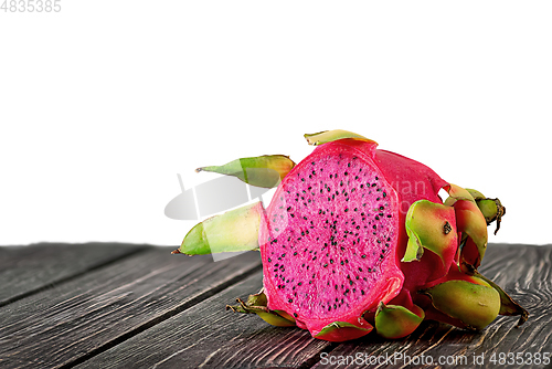 Image of Half dragon fruit on planks isolated on white