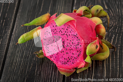 Image of Half dragon fruit on a wooden planks