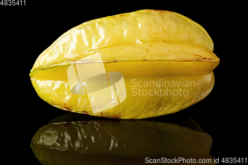 Image of Ripe yellow carom with reflection on black