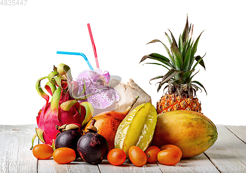 Image of Tropical fruits on wooden table isolated on white